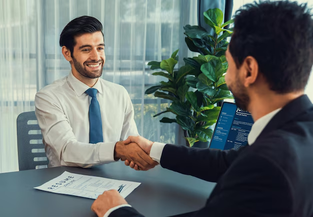 Immigration consultant shaking hands with a client during a visa consultation discussing December 2025 immigration policy changes.