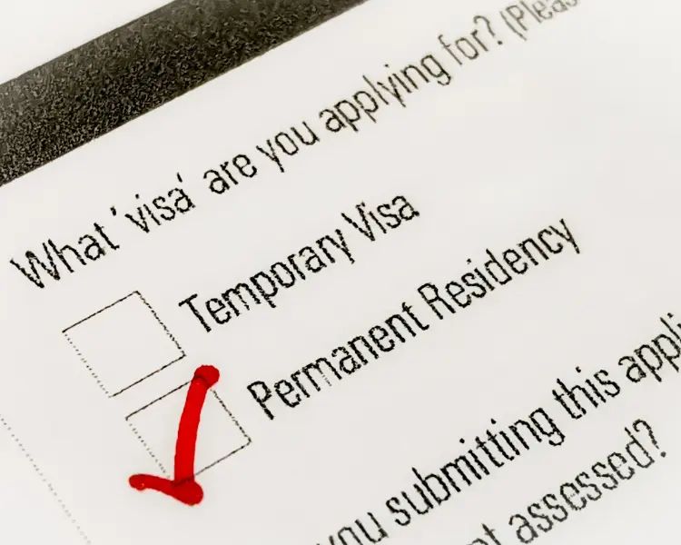 Form showing visa options with a red checkmark highlighting Permanent Residency, symbolizing the distinction between PR and citizenship pathways in 2026.